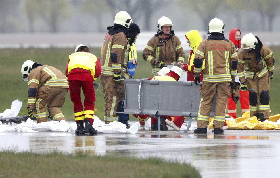 Firefighters assist mock casualties during an emergency drill at Berlin Brandenburg international Willy Brandt airport in Schoenefeld