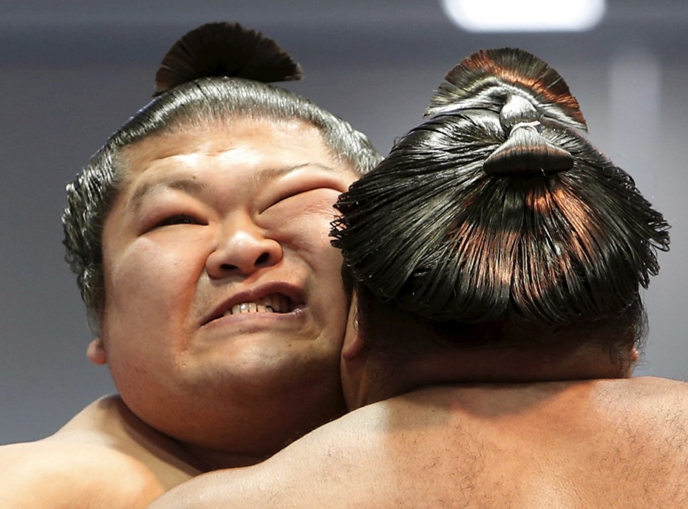 Sumo wrestlers compete during the annual 'Honozumo' ceremonial sumo tournament dedicated to the Yasukuni Shrine in Tokyo, Japan