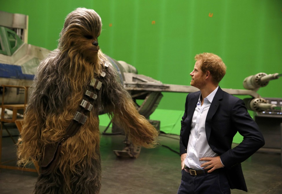 Britain's Prince Harry meets Chewbacca during a visit to the Star Wars film set at Pinewood Studios near Iver Heath, west of London