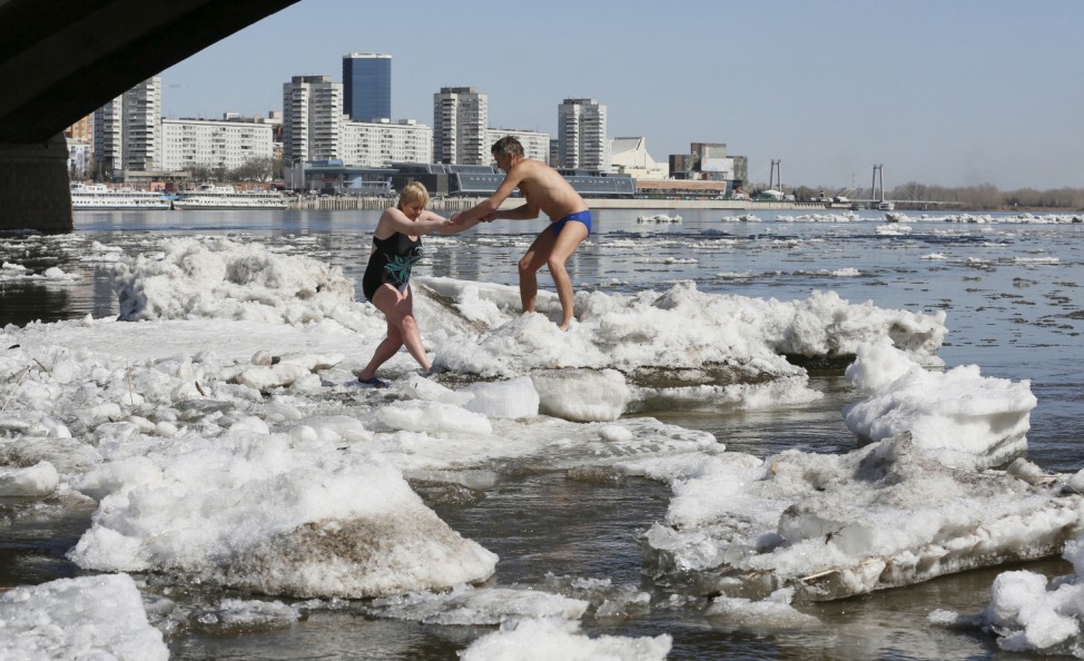 Members of the Cryophile winter swimmers' club walk on ice floes during an ice drift on the Yenisei river in Krasnoyarsk, Siberia, Russia