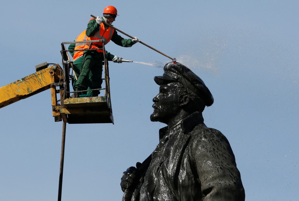 Workers wash statue of Soviet state founder Lenin in Krasnoyarsk