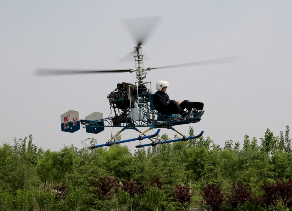 Sixty-year-old villager Guo Leiting, flies his home-made helicopter in Yuncheng
