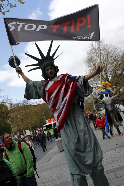 Protesters depicting Statue of Liberty and Europa on the bull take part in a demonstration against TTIP free trade agreement ahead of U.S. President Obama's visit in Hannover, Germany April 23, 2016.