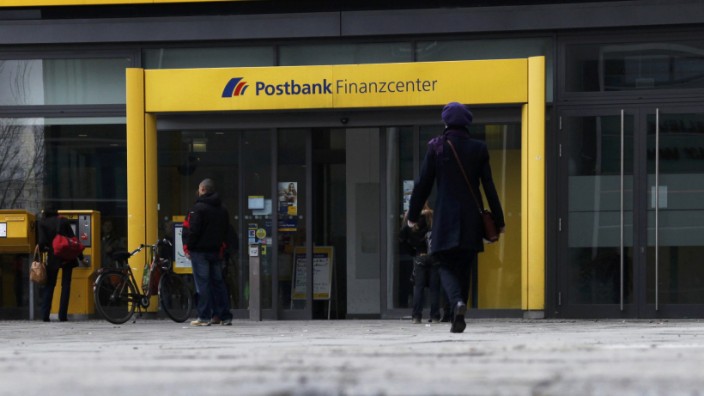 File photo of people entering a building of Deutsche Postbank AG in Berlin