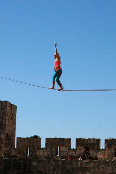 American slackliner Heather Larsen crosses a high wire between two towers at the Tower of David Museum in Jerusalem's Old City