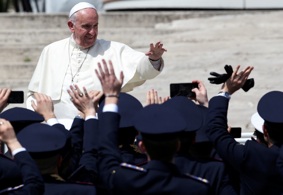 Pope Francis waves as he leaves at the end of a mass for the Armed Forces Jubilee in Saint Peter's Square at the Vatican