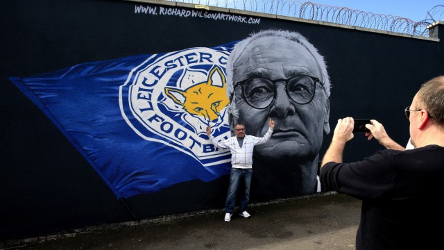 Leicester City: Erinnerungen: Leicester-Fans lassen sich vor dem Graffiti-Porträt von Trainer Ranieri fotografieren, das der Street-Art-Künstler Robert Wilson fertigte.