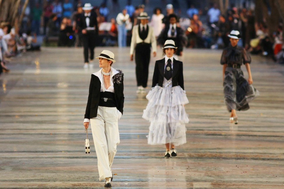 Models present creations by German designer Karl Lagerfeld as part of his latest inter-seasonal Cruise collection for fashion house Chanel at the Paseo del Prado street in Havana, Cuba
