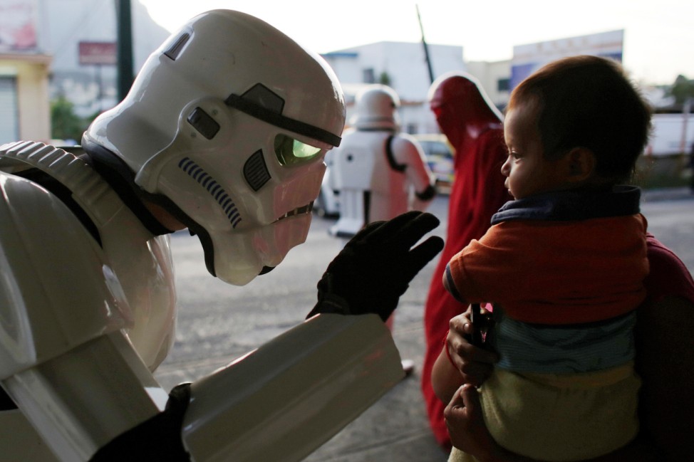 Member of the Star Wars fan club, dressed as a Stormtrooper, talks to a girl outside a hospital's emergency ward during Star Wars Day celebrations in Monterrey