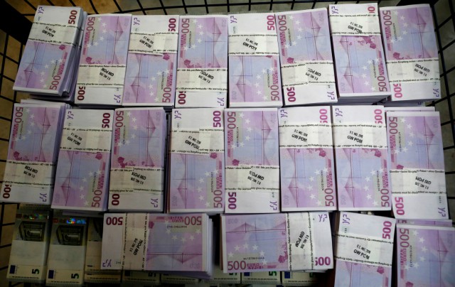Wads of 500 euro banknotes are stacked in a pile at the Money Service Austria company's headquarters in Vienna