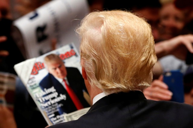 Republican U.S. presidential candidate Donald Trump signs autographs after speaking at a campaign rally in Costa Mesa