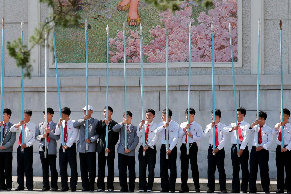 Students hold flag poles as they practice for an apparent parade to celebrate the Workers' Party of Korea Congress in central Pyongyang