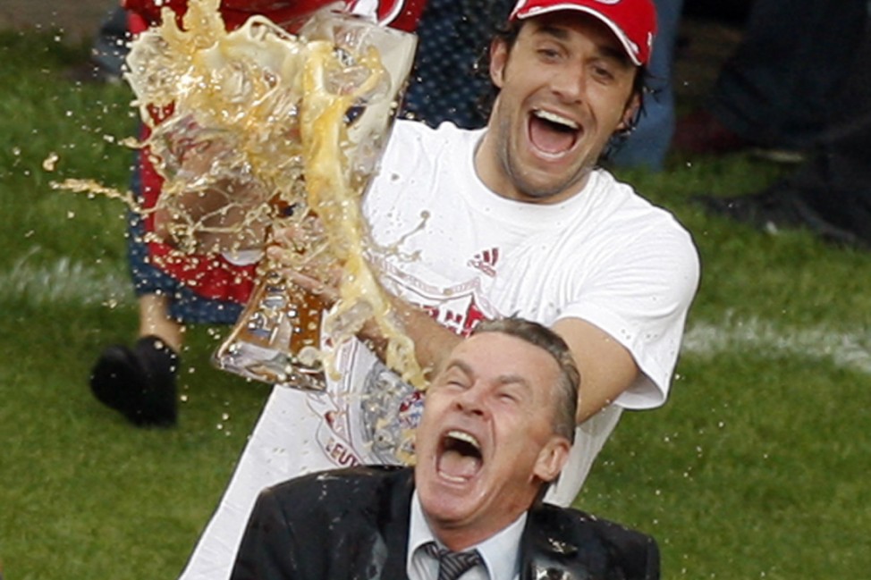 Bayern Munich's coach Hitzfeld gets showered with beer by Toni as they celebrate winning German Bundesliga title following first division match against VfL Wolfsburg in Wolfsburg