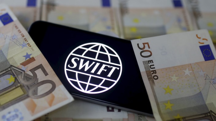 Swift code bank logo is displayed on an iPhone 6s on top of Euro banknotes in this picture illustration made in Zenica