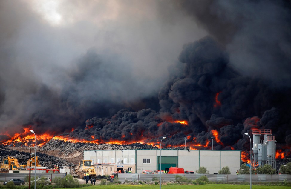 A fire rages at a tyre dump near a residential development in Sesena