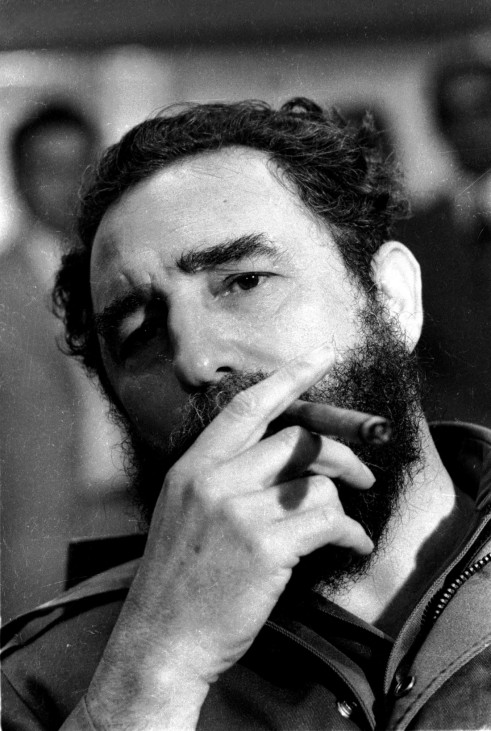 File photo of Cuba's President Castro smoking cigar during news conference in Havana