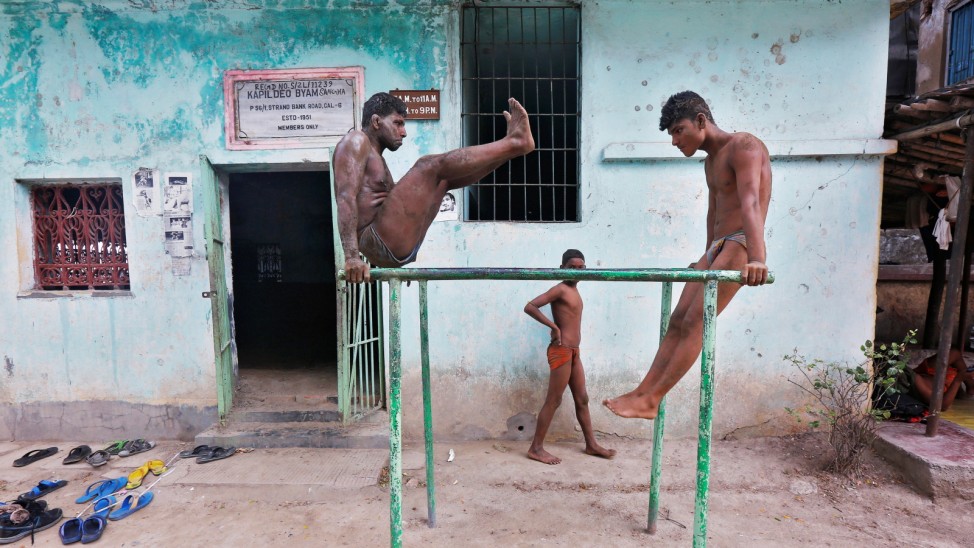 Wrestlers exercise at a traditional Indian wrestling training centre on the banks of the river Ganges in Kolkata