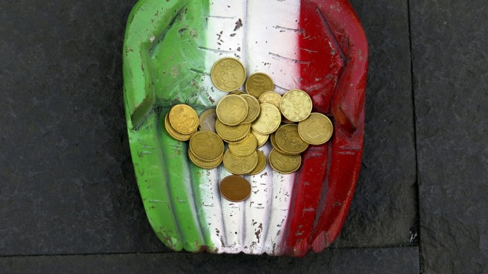 File photo of Euro coins seen on the figure of a pair of hands, which are painted in Italy's colour national colours, on the ground in downtown Rome