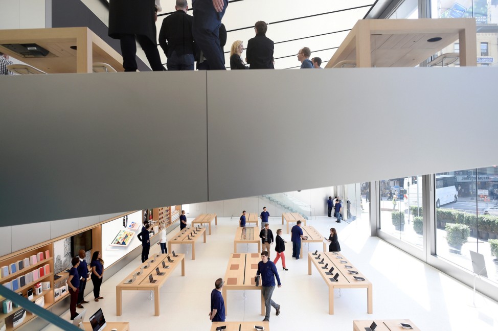 Workers staff a new Apple retail store during a media preview in San Francisco