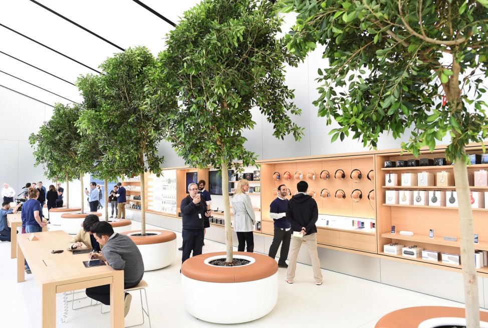 Trees line a second floor retail area for audio accessories at the media preview for a new Apple retail store in San Francisco
