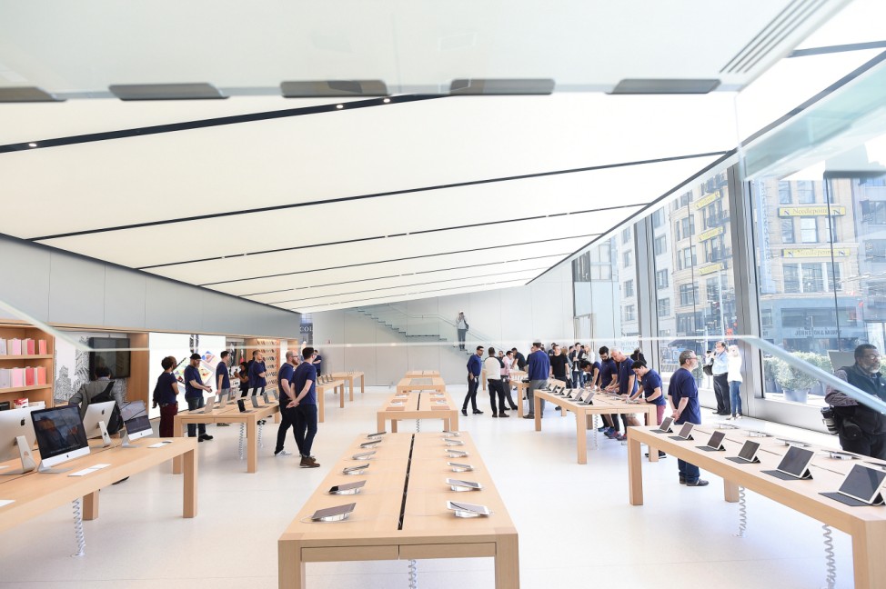 Workers staff a new Apple retail store during a media preview in San Francisco