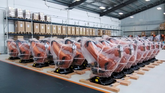 Robots covered in plastic sheets are seen at a plant of Kuka Robotics in Shanghai