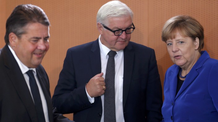 German Economy Minister Gabriel, German Minister for Foreign Affairs Steinmeier and German Chancellor Merkel arrive for the weekly cabinet meeting at the Chancellery in Berlin