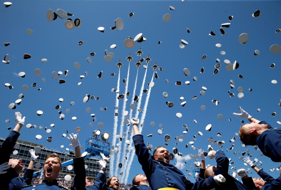 The Thunderbirds perform a fly-over as graduates from the Air Force Academy toss their hats in the air at the conclusion of their commencement ceremony in Colorado Springs