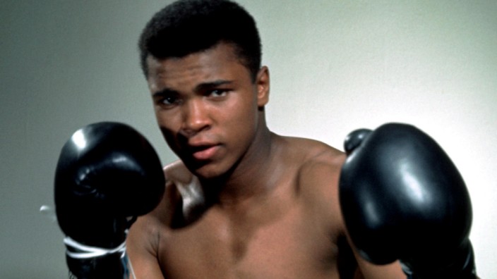 Muhammad Ali poses with gloves in this undated portrait.
