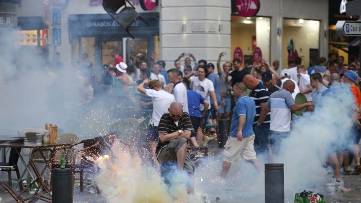 A teargas grenade explodes near an England fan ahead of England's EURO 2016 match in Marseille