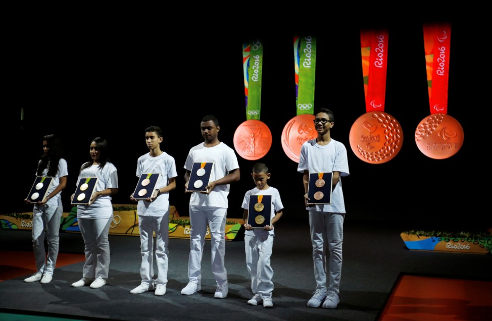 Children and youth show Rio 2016 Olympic and Paralympic medals during the medal launching ceremony in Rio de Janeiro