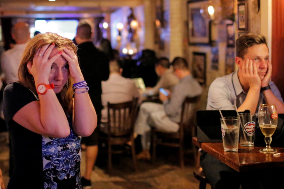 People gathered in The Churchill Tavern, a British themed bar, react as the BBC predicts Britain will leave the European Union, in the Manhattan borough of New York
