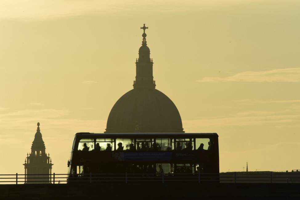 A bus carries commuters as it travels over Waterloo Bridge in London