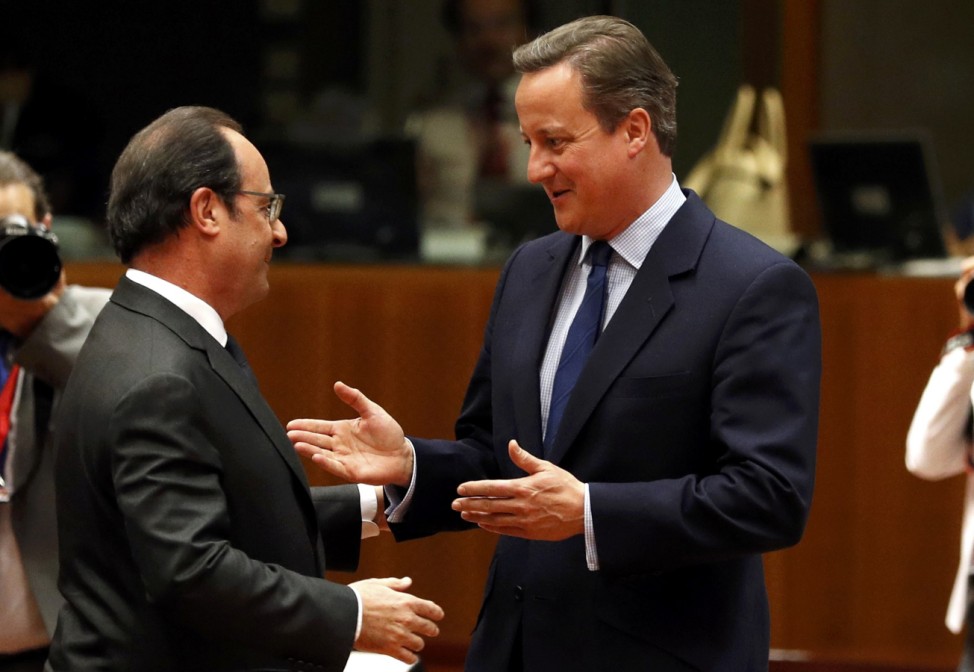 French President Hollande talks with Britain's PM Cameron during the EU Summit in Brussels