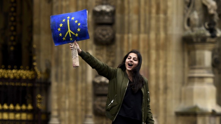 A demonstrator stands outside the Houses of Parliament during a protest aimed at showing London's solidarity with the European Union following the recent EU referendum, in central London