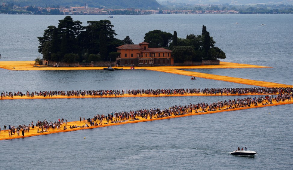 People walk on the installation 'The Floating Piers' by Bulgarian-born artist Christo on Lake Iseo