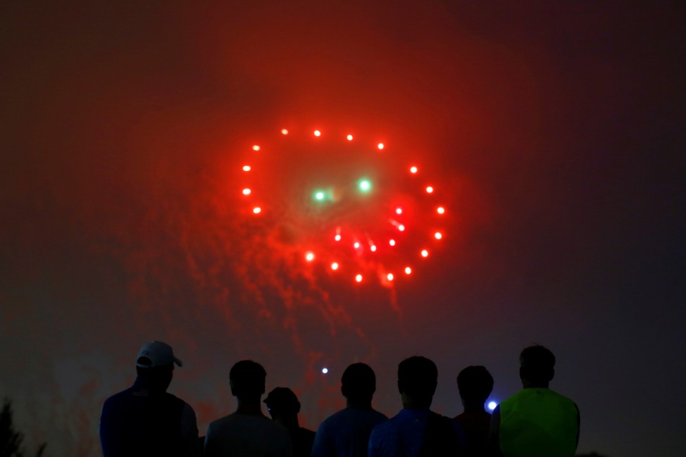 People watch fireworks in the form of a 'smiley face' during the 4th of July Independence Day celebrations at the National Mall in Washington, U.S.