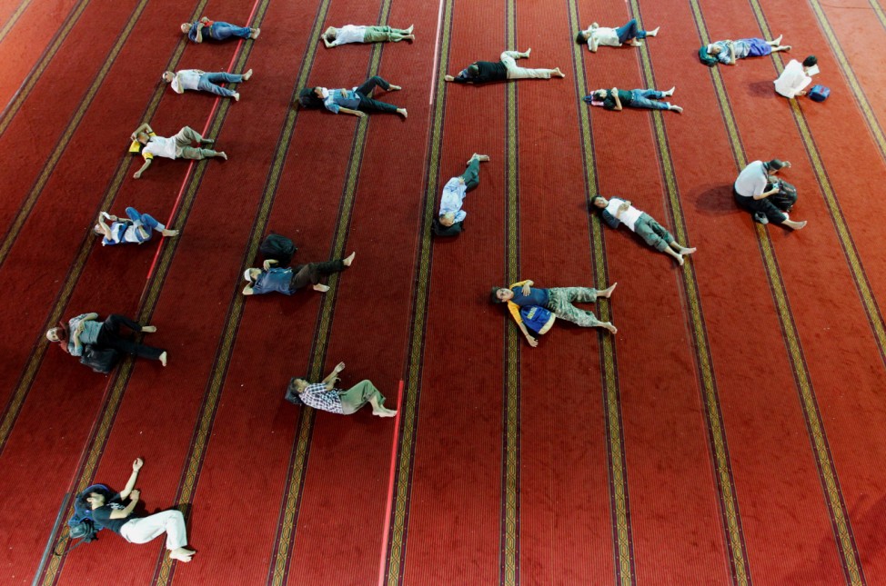 Muslim men rest inside Istiqlal mosque on the last day of the holy fasting month Ramadan in Jakarta