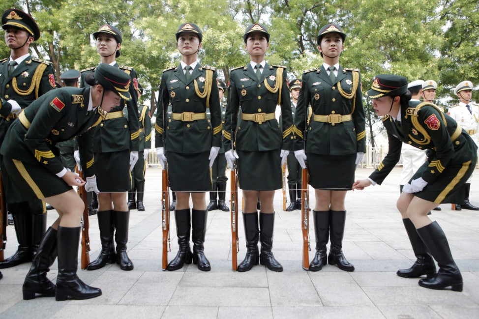 A string is used to ensure that the skirts of female members of the honour guard are in the same height from the ground in Beijing