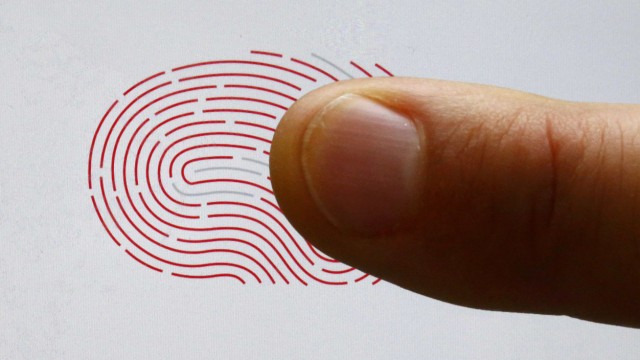 A person uses a sensor for biometric identification on a smartphone in Berlin