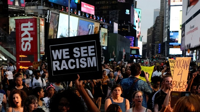 People take part in a protest against the killings of Alton Sterling and Philando Castile during a march through Times Square in New York