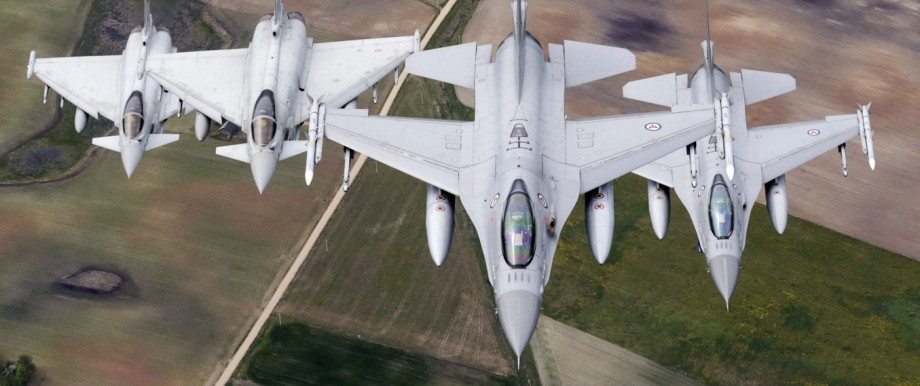 Norwegian Air Force's F-16 fighters and Italian Air Force's Eurofighter Typhoon fighters patrol over the Baltics during a NATO air policing mission from Zokniai air base near Siauliai