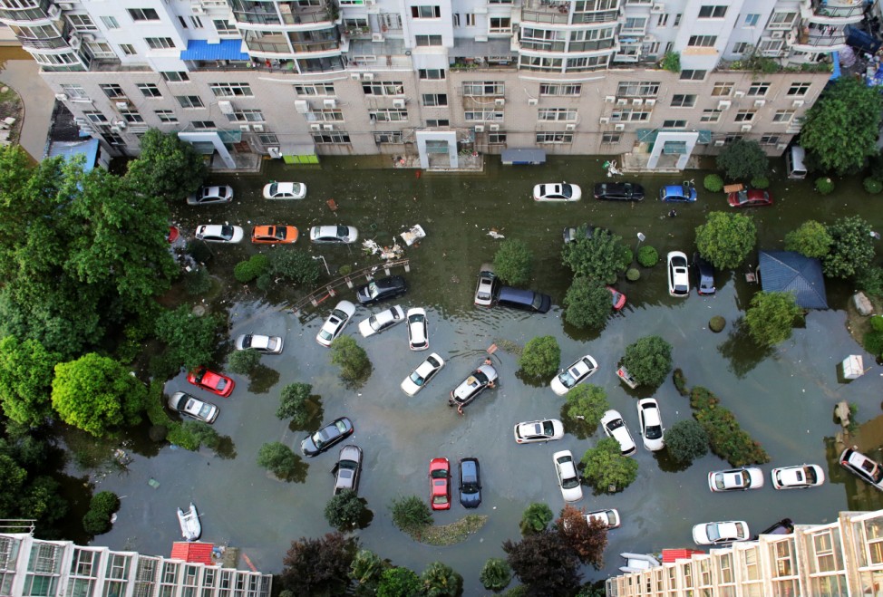 Automobiles are seen flooded at a neighbourhood in Wuhan