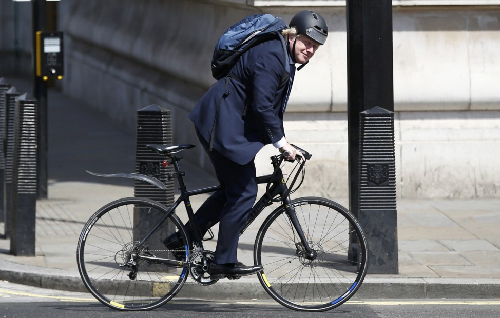 Conservative party MP, Boris Johnson, rides his bike along Whitehall in London