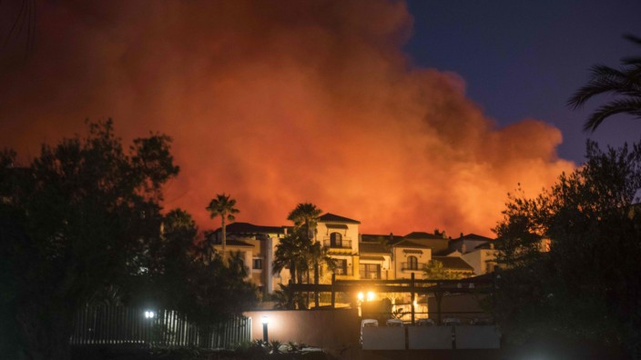 Spanien: Flammen sind hinter dem Hotel in La Línea de la Concepción in der Provinz Cádiz zu sehen.