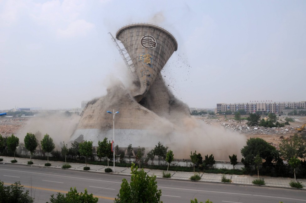 A cooling tower is seen under mechanical demolition in Binzhou