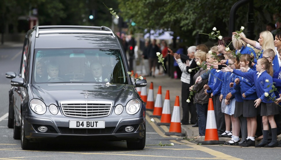 School children and teachers throw flowers on to the hearse carrying murdered Member of Parliament Jo Cox's as her funeral cortege will passes through Heckmondwike in northern Britain
