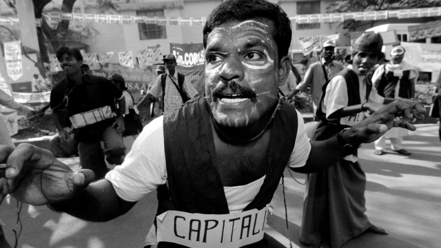 An Indian activist mimicks capitalism's hunger toward workers