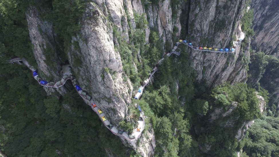 Tents are seen set up along a mountain road during a camping festival in Luoyang