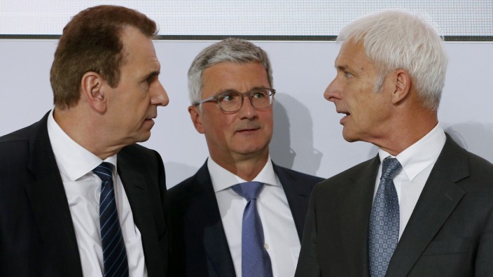 Blessing, Volkswagen Group Board Member, Audi Chief Executive Officer Stadler and Volkswagen CEO Mueller chat after the annual news conference in Wolfsburg